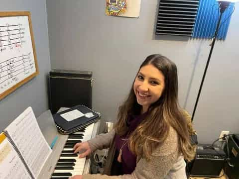 a woman sitting at a piano