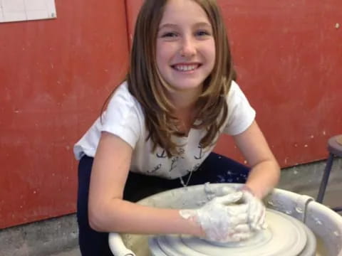 a woman holding a bucket of dirt