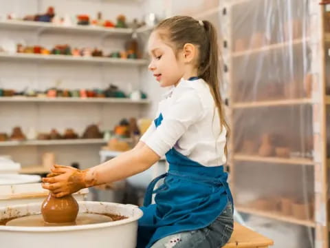 a young girl making a cookie