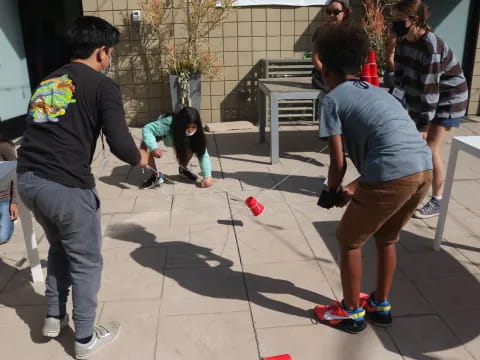 a group of people playing with a toy