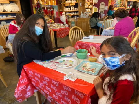 a person and a girl eating at a table