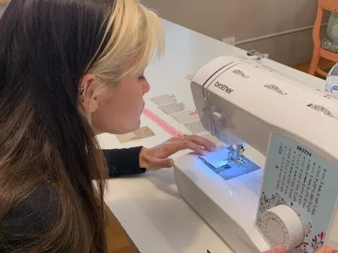 a woman looking at a sewing machine