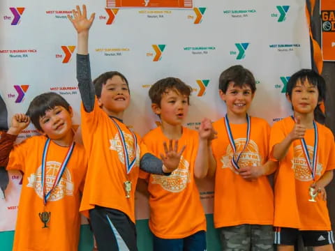 a group of boys wearing orange shirts