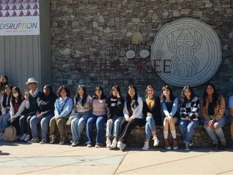 a group of people sitting on a bench