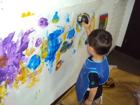 a child painting on a wall