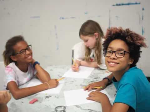 a group of young girls sitting at a table