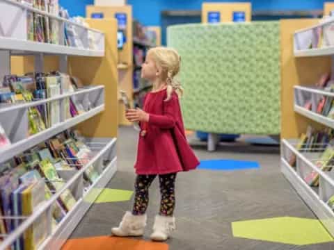 a girl standing in a library