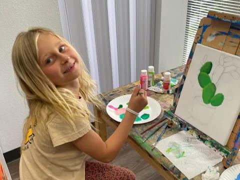 a girl sitting at a table