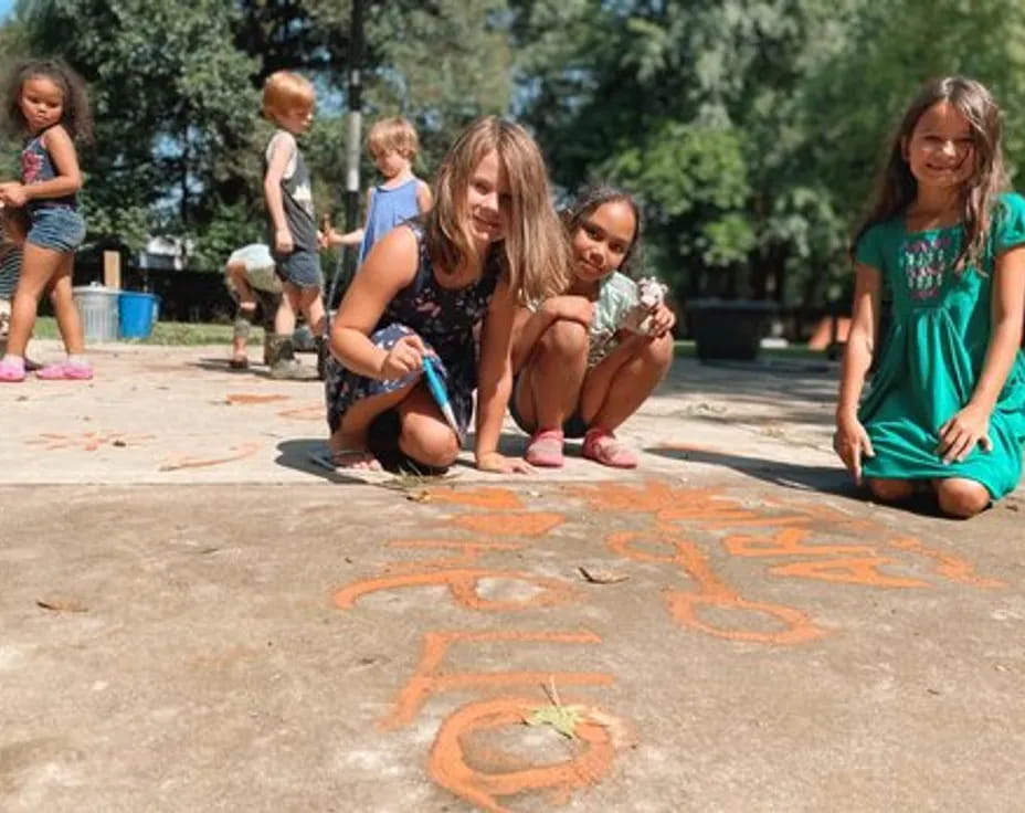 a group of children sitting on the ground