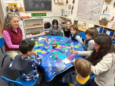 a group of children sitting around a table