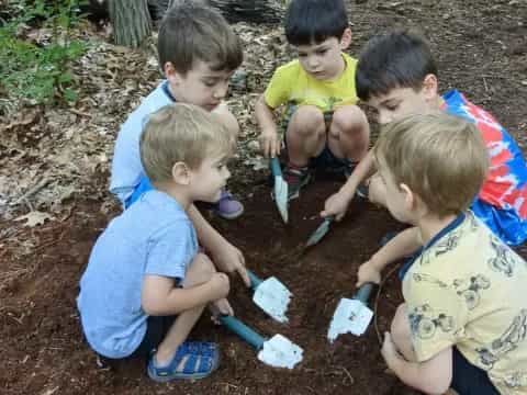 a group of boys playing with sand