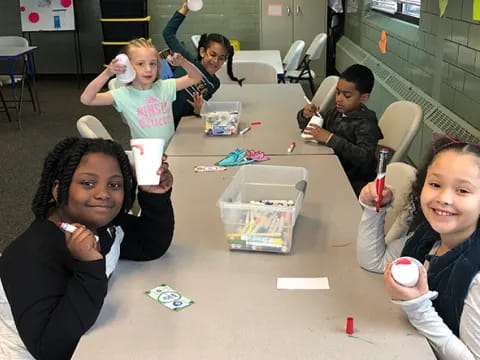 a group of children sitting at a table