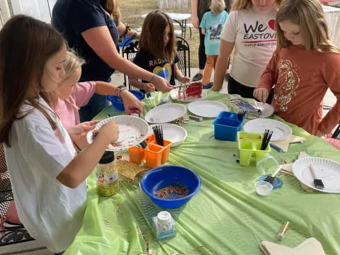 a group of people gathered around a table with food