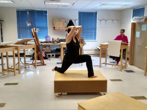 a person doing a yoga pose in a classroom