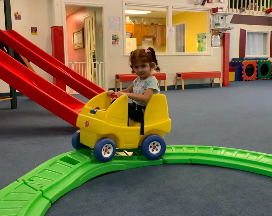 a child riding a toy train