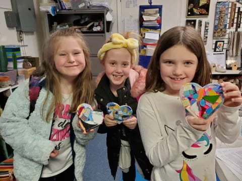 a group of girls holding toys