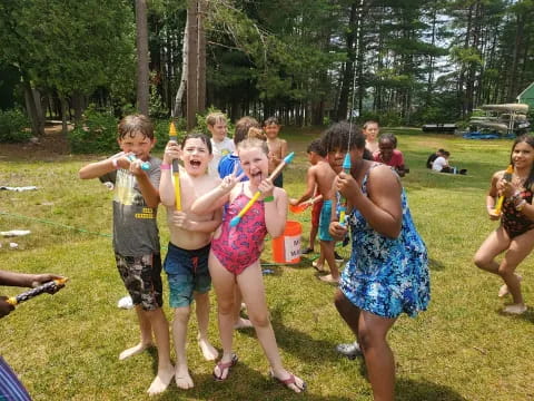 a group of children holding sticks