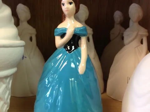 a toy doll in a blue dress