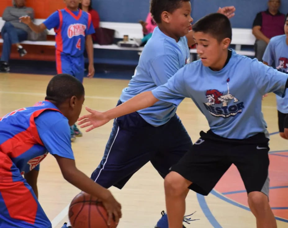 a group of boys playing basketball