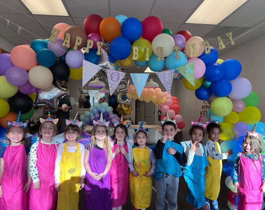 a group of people posing for a photo with balloons