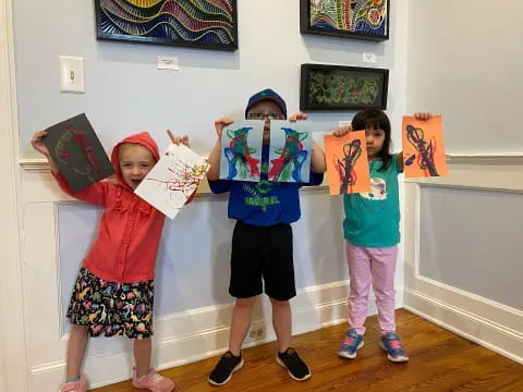 a group of children holding up books