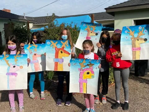 a group of girls holding up a sign