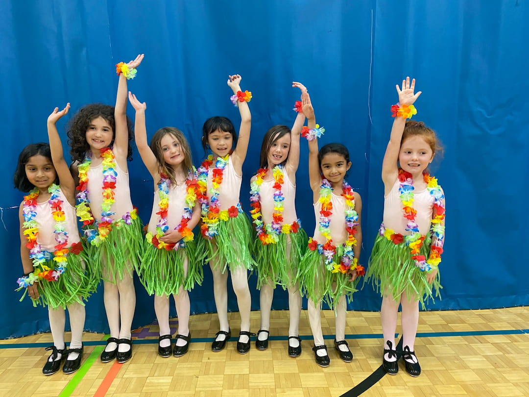 a group of girls in colorful dresses