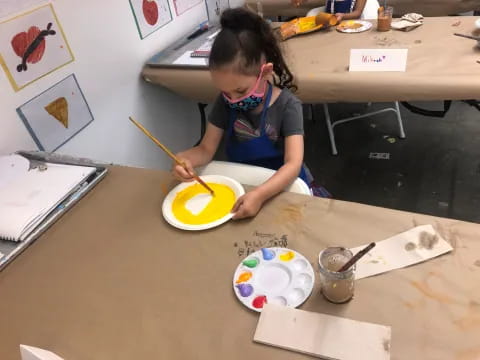 a child painting on a table