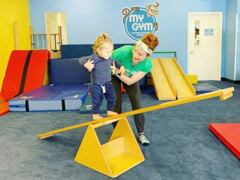 a couple of kids playing on a playground toy