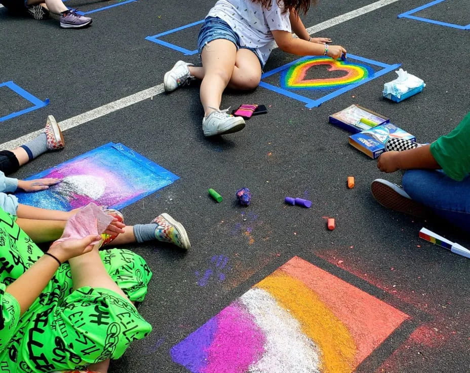 a group of people painting on the ground