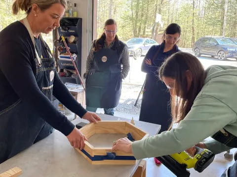 a group of women looking at a box