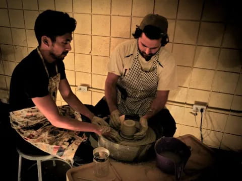 a couple of men cooking in a kitchen