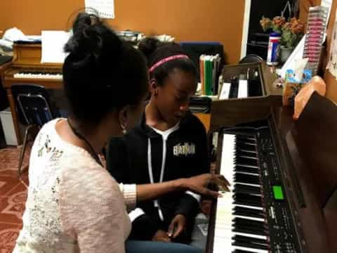 a group of women playing piano