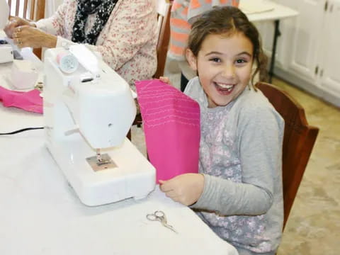 a child using a sewing machine