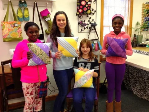 a group of girls holding bags