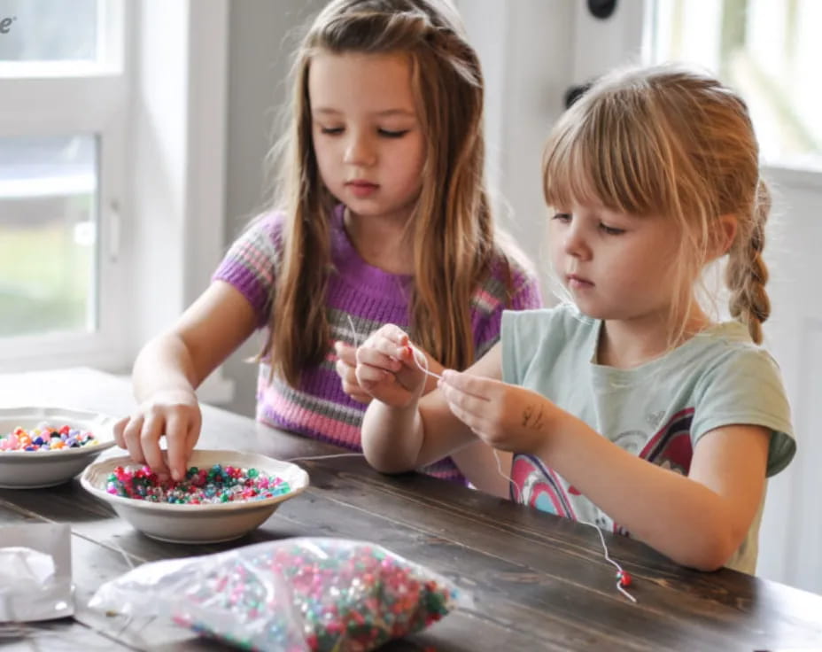 a couple of young girls eating cereal