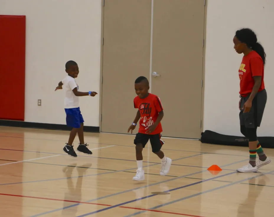 a group of kids playing basketball