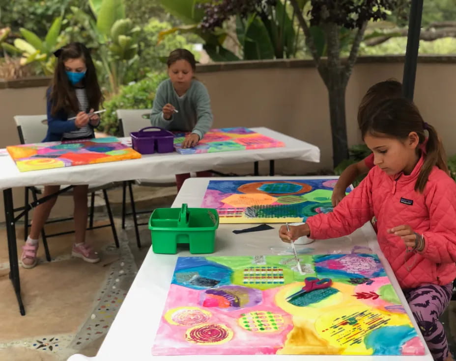 children painting on a table