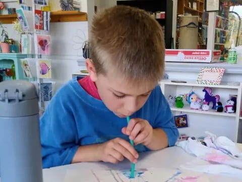 a child coloring on a paper