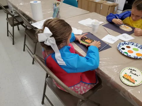 a girl sitting at a table eating