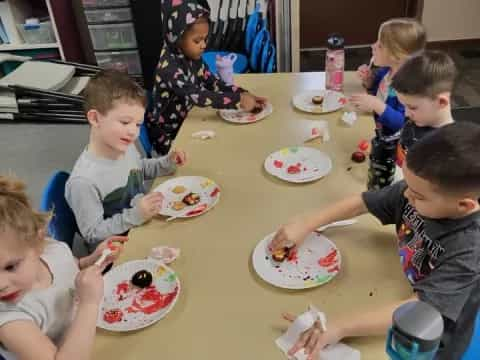 a group of kids eating at a table