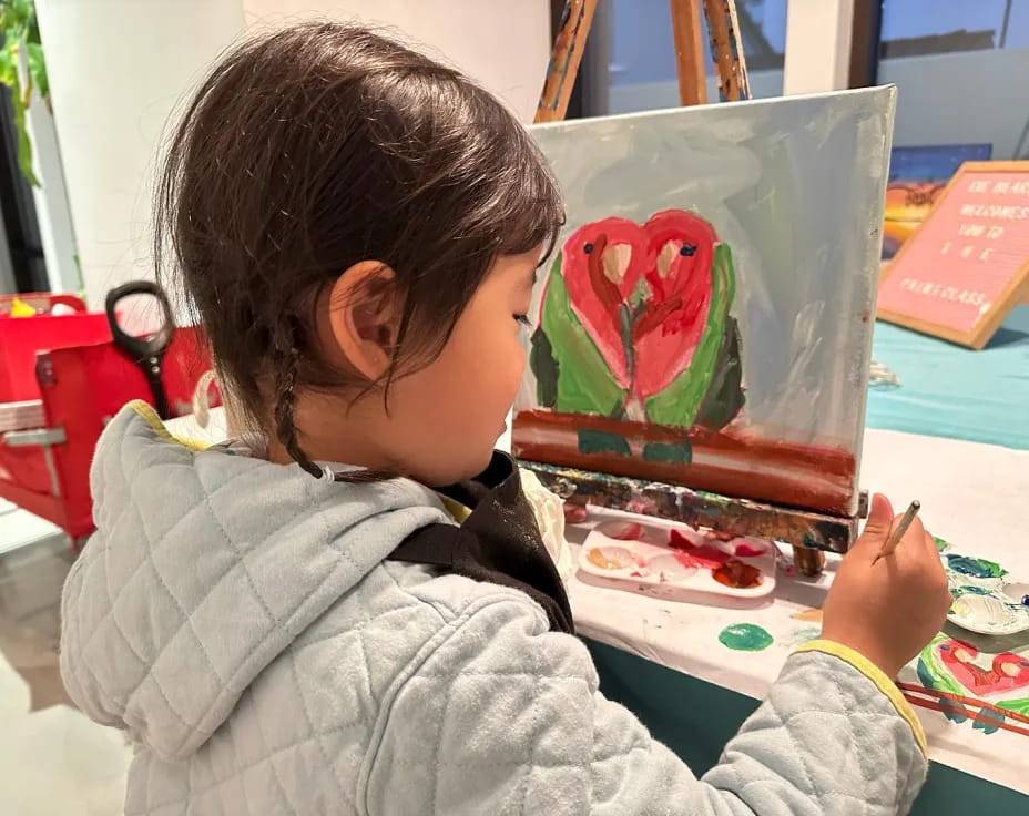 a child painting on a table