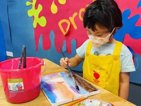 a child painting on a table
