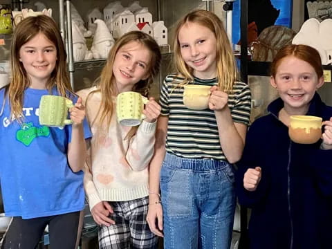 a group of girls holding cups