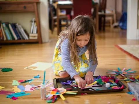 a girl coloring on a paper