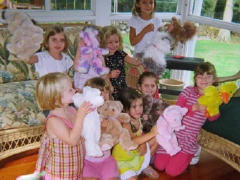 a group of children holding stuffed animals