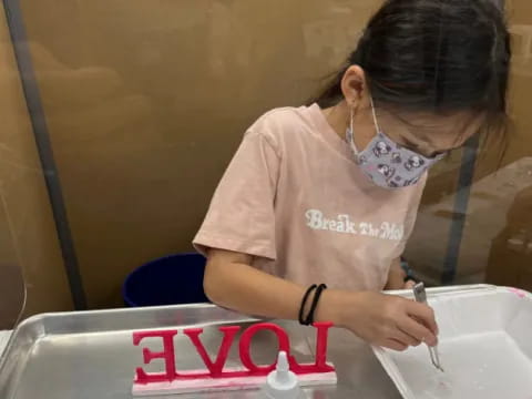 a person painting a sign