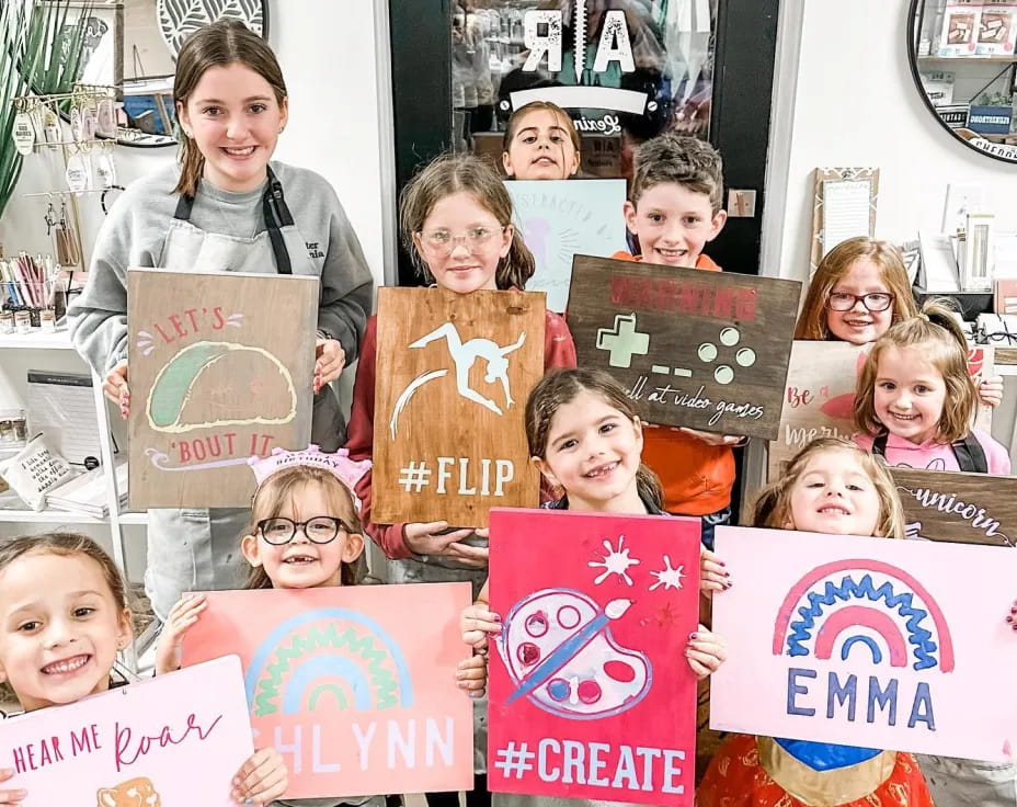 a group of children holding signs