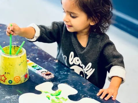 a child painting on a table