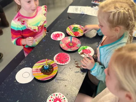kids eating cupcakes on a table